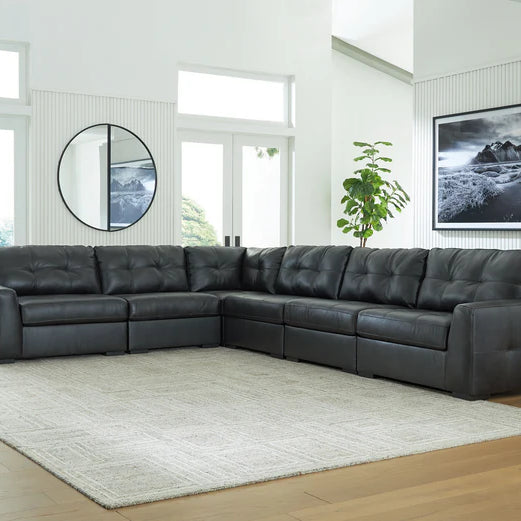 A stylish living room with a black leather sectional sofa, earthy tones, and cozy decor reflecting southeastern U.S. lifestyle.
