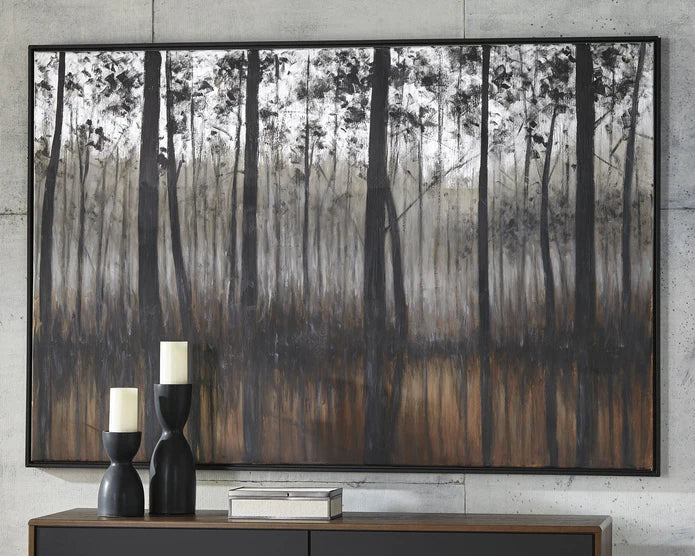 A close up of living room wall with tree wall art above a console table accented with stylish black modern candle holders .