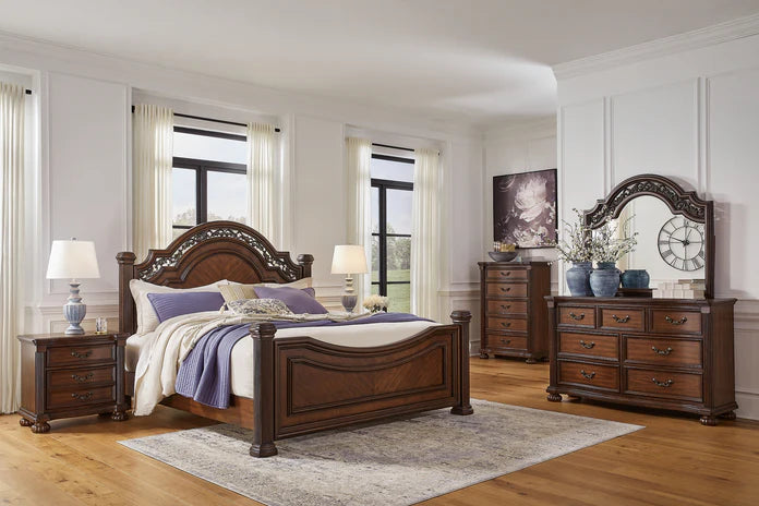 A cozy and stylish bedroom with a queen bed set, featuring soft lighting, plush bedding, and warm earthy tones, reflecting a community-focused brand aesthetic.