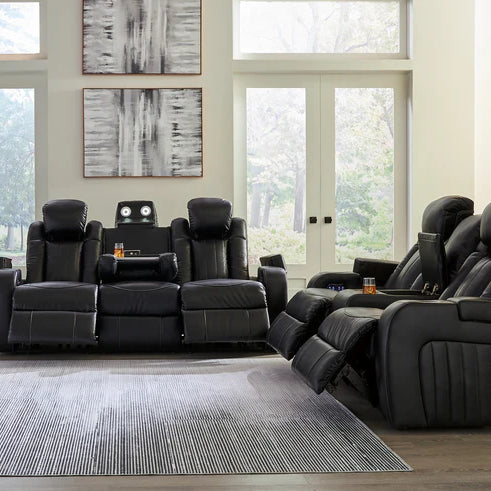 A cozy living room scene centered around a luxurious leather power reclining sofa, with warm ambient lighting and modern decor elements reflecting a southeastern U.S. aesthetic.
