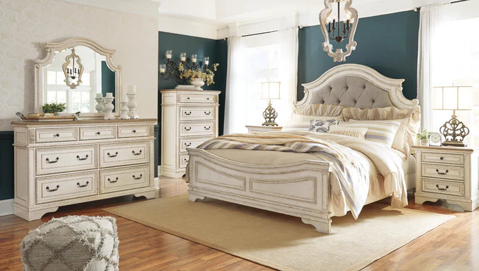 A cozy bedroom with a stylish queen bed, dresser, and nightstands in earthy tones.