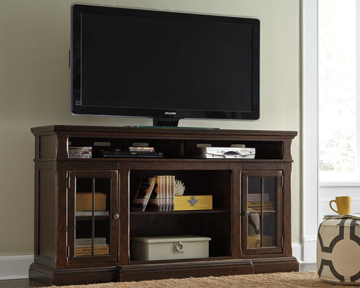 The beauty of this TV stand will immediately engage you. The slight breakfront shape is a rare find and an ideal fit among traditional and eclectic tastes. Soft black undertones highlight the warm finish. Multiple cubbies and glass-door enclosed shelves organize your audio/video components and plenty of extras. Sold separately, an electric fireplace fits neatly in the center cubby.