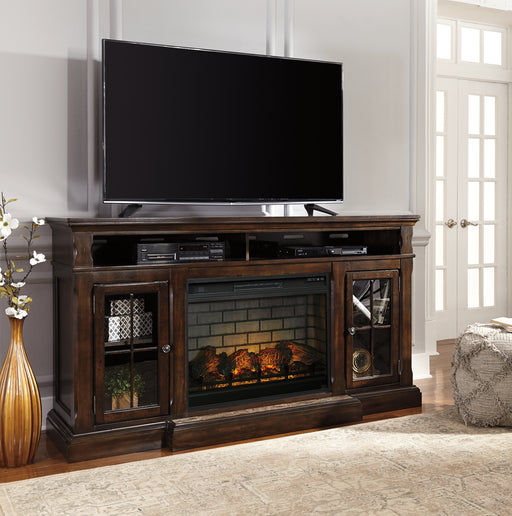 The beauty of this TV stand will immediately engage you. The slight breakfront shape is a rare find and an ideal fit among traditional and eclectic tastes. Soft black undertones highlight the warm finish. Multiple cubbies and glass-door enclosed shelves organize your audio/video components and plenty of extras. What really turns up the heat: an electric infrared fireplace insert with faux firebrick