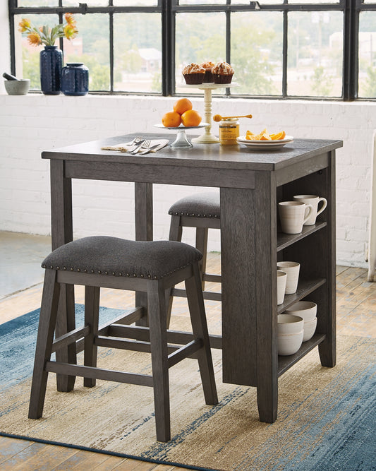 Perfect portion. Striking a simply chic pose, this counter height dining room table set serves up high style on a smaller scale. Its antiqued gray wash finish gives the clean-lined design a casually cool sensibility. Ideally sized for dinner for two or as an impromptu workspace, side shelves cleverly balance form and function. Covered in a textured gray fabric, the stool’s cushioned seat goes easy on the body.