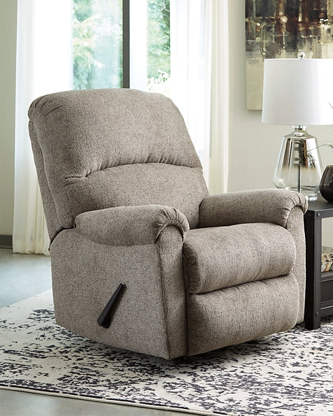 A mastery in less is more, this rocker recliner manages to make cool, contemporary design so warm and cozy. A new twist on neutral, the recliner’s soothing “smoky” gray upholstery is incredibly plush to the touch. Curved divided back and deeply tufted footrest give the clean-lined profile a sense of sumptuousness impossible to resist.