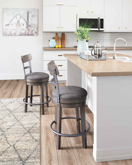 Bring a relaxed yet refined sense of good taste to a space with this upholstered swivel bar stool. The sturdy wood frame with contoured backrest is beautified with an antiqued gray wash finish that’s easy on the eyes. Rest assured, this bar stool caters to your comfort with a cushioned seat with gray textured fabric accentuated with nailhead trim. Sensible swivel design keeps you in the flow of conversation.