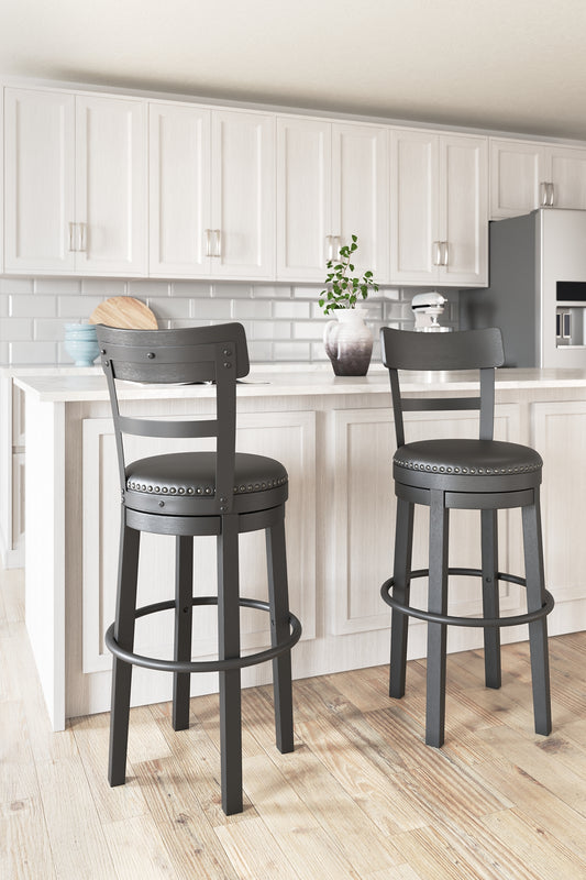 Bring a dash of drama to a kitchen island, table or counter with this pair of upholstered swivel bar stools. The sturdy wood frame with contoured backrest is beautified with an antiqued black finish that’s a welcome change from the everyday ordinary. For your comfort and convenience, the bar stool seat is covered in a durable black faux leather designed for easy cleanup. Nailhead trim and metal accents perfect the aesthetic of this head-turning bar stool with 360-degree swivel.